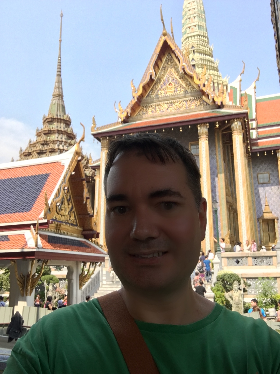 Raymond in front of the spires and gold trim of the Grand Palace in Bangkok, Thailand.