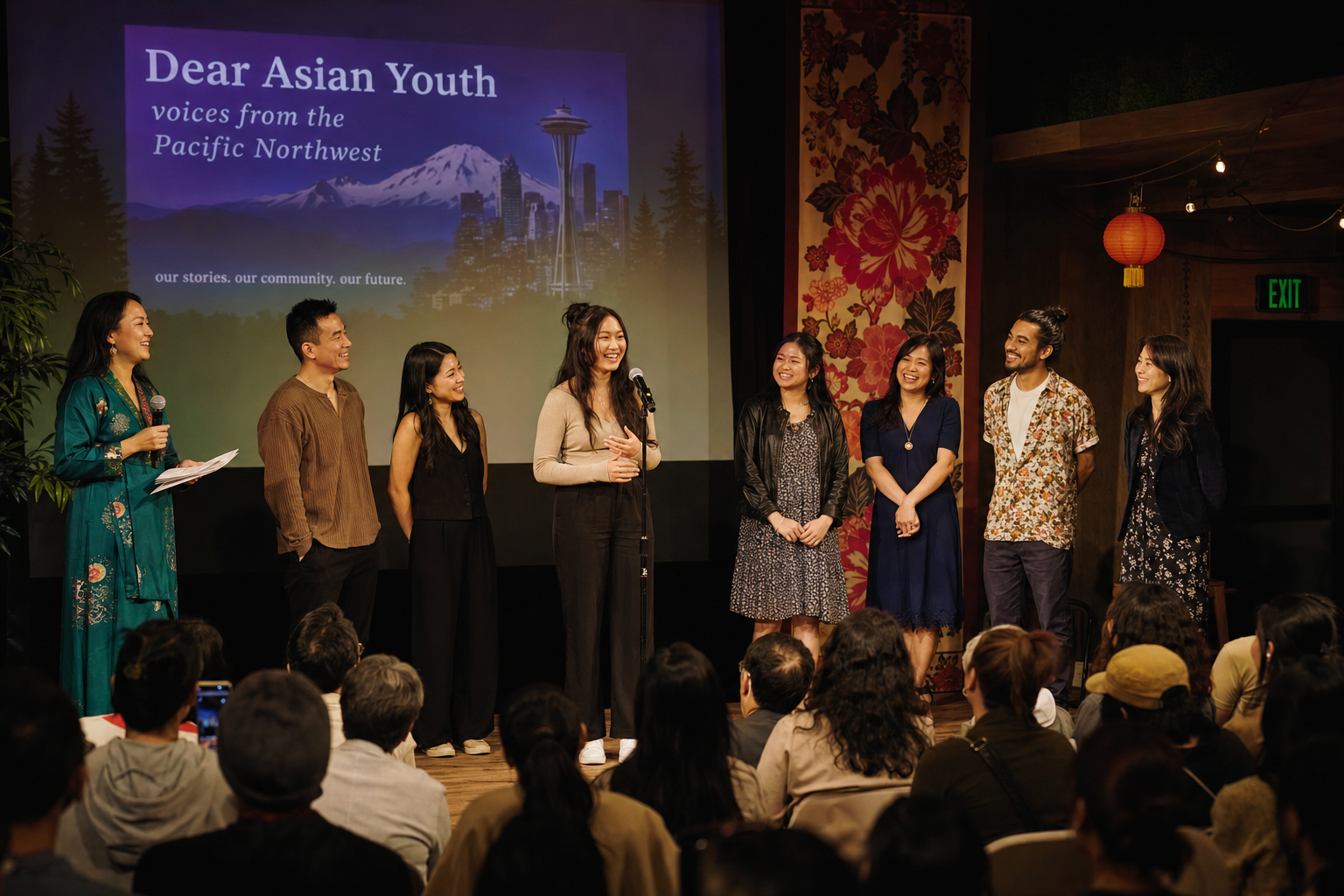 Diverse performers on stage sharing personal stories at a Pacific Northwest cultural event