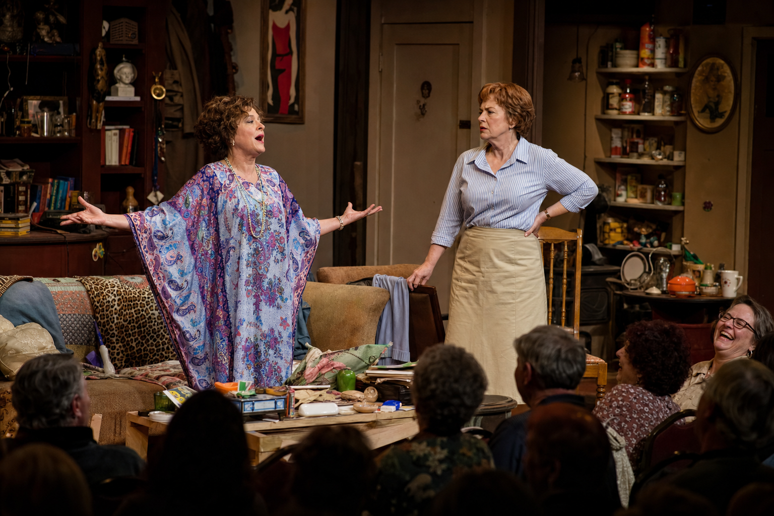 Two women perform The Odd Couple on stage, comedy scene with mismatched roommates and audience laughing